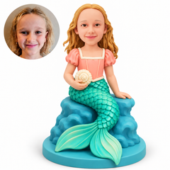 custom bobblehead figure girl mermaid holding a seashell while seated on a rock