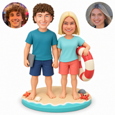 custom bobbleheads figures beach couple holding hands with a swim ring and a flat rectangular accessory
