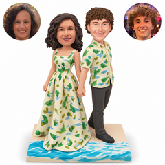 custom bobbleheads figures couple facing outward and holding hands at their sides on a beach base