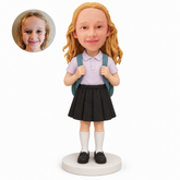 Custom bobblehead schoolgirl in collared blouse and black pleated skirt holding backpack straps