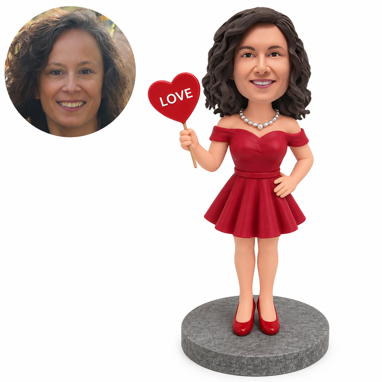 Custom clay bobblehead woman in a deep red dress holding up a heart sign with one hand on her hip