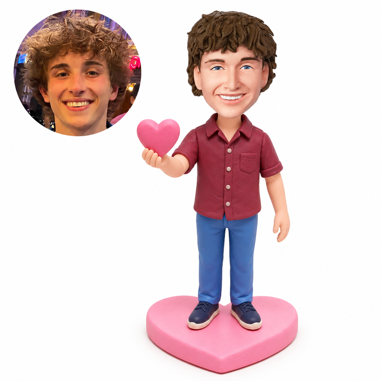 Custom clay bobblehead man offering a pink heart in a burgundy shirt on a heart-shaped base