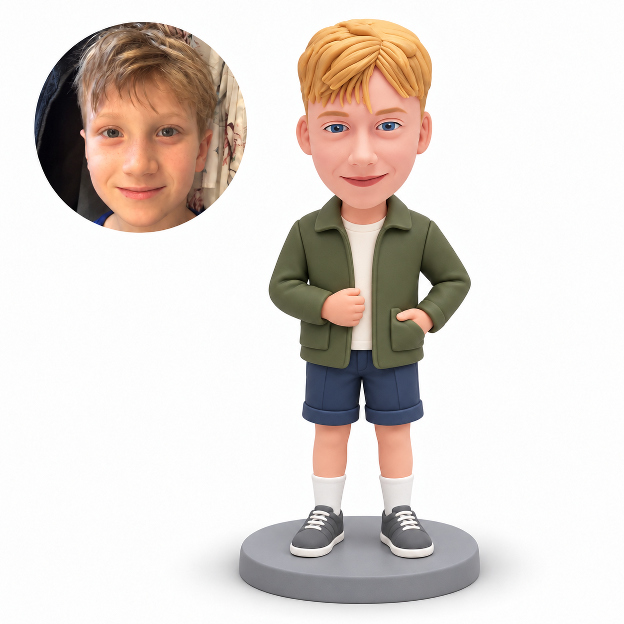 Custom polymer-clay boy in an olive jacket with his left hand inside the jacket patch pocket and right hand at the jacket front, with matching real child portrait