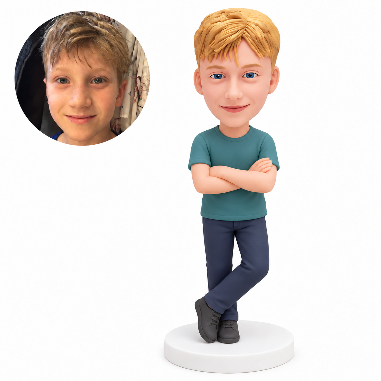 Custom polymer-clay boy in a teal T-shirt and navy trousers, standing with folded arms and his left leg crossed in front on its forefoot, on a plain round base, with matching real child portrait
