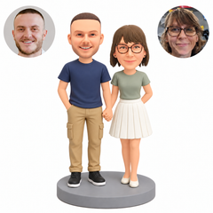 Custom polymer-clay couple holding hands, his right hand in a pocket and her left arm behind her back, MGA-AC1784