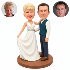 Custom clay wedding couple: bride lifting her skirt and resting a hand on his shoulder, groom with hand at her waist and outer arm lowered, original clay heads and paired real-photo circles. MGA-AC1794.