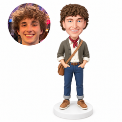 Custom polymer-clay bobblehead man with both hands in his front pockets and a brown crossbody satchel, with matching real-photo inset – MGA-AC1827