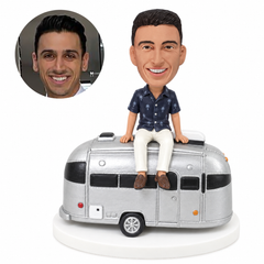 custom bobblehead figure traveler sitting on a camping trailer
