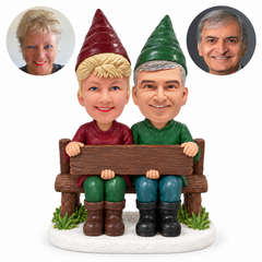 custom bobblehead figures garden gnome couple sitting on a bench and holding a wooden sign