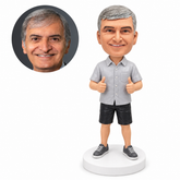 custom bobblehead figure man in a short sleeve shirt and shorts giving two thumbs up