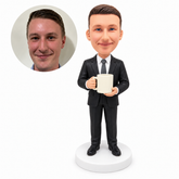 custom bobblehead figure businessman in a suit holding a coffee mug with both hands