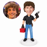 custom bobblehead figure male repairman holding a toolbox and raising a cordless drill