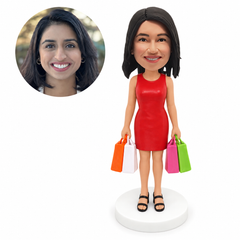 custom bobblehead figure woman in a sleeveless mini dress holding shopping bags in both hands