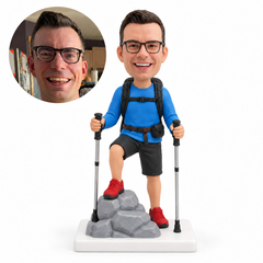 custom bobblehead figure male hiker with one foot on rocks and two trekking poles