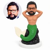 custom bobblehead figure merman seated on a rock with both hands behind his head