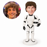 custom bobblehead figure man in white space armor holding a helmet with one arm lowered