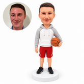 custom bobblehead figure male basketball coach in a hoodie and shorts holding a ball at his hip