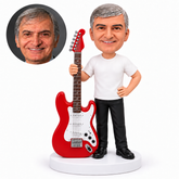 custom bobblehead figure man beside an oversized electric guitar with one hand on his hip