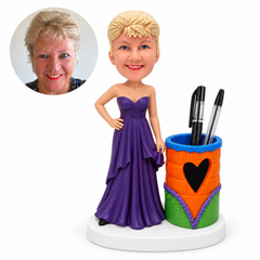 custom bobblehead figure woman in a strapless gown beside a heart pen holder