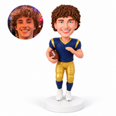 custom bobblehead figure male football player holding a ball at his hip with one hand raised