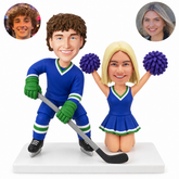 custom bobblehead figures hockey player beside a kneeling cheerleader with raised pom poms