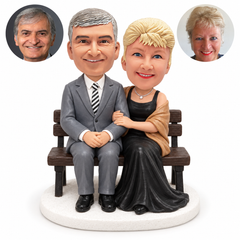 custom bobblehead figures formal couple seated closely on a wooden bench
