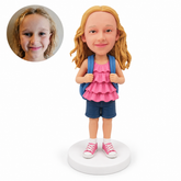 custom bobblehead figure schoolgirl in a ruffled top and shorts holding backpack straps