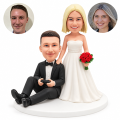 custom bobblehead figures wedding couple with the groom seated on the floor holding a game controller