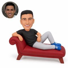 custom bobblehead figure man in a T-shirt and full trousers reclining on a chaise longue