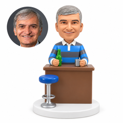 custom bobblehead figure male bartender in a polo shirt behind a bar counter with a stool