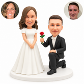 custom bobblehead figures wedding couple with a suited man kneeling and offering a rose to a standing bride