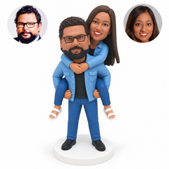 custom bobblehead figures piggyback couple with both people wearing denim jackets and jeans