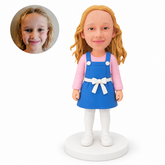 custom bobblehead figure girl standing in a denim pinafore dress over a long-sleeved top and tights