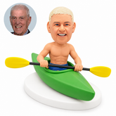 custom bobblehead figure shirtless man seated in a kayak holding a double-bladed paddle across the cockpit
