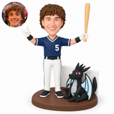 custom bobblehead figure baseball player raising a bat and making a horns gesture beside a decorative dragon