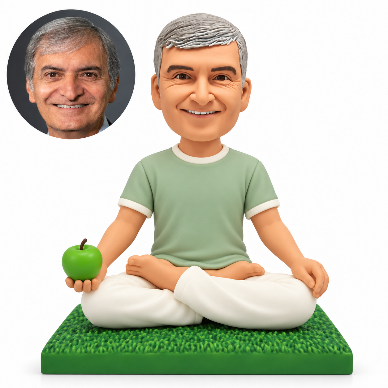 custom bobblehead figure male sitting cross-legged holding a green apple