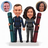 custom bobblehead figures skydiving couple holding two tall ski bags