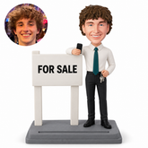 custom bobblehead figure male real estate agent with a phone and keys beside a for sale sign