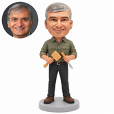 custom bobblehead figure male woodworker holding a mallet and chisel across his waist