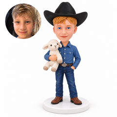 Custom young cowboy bobblehead holding a plush lamb