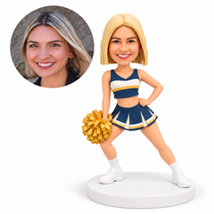 custom bobblehead figure female cheerleader holding one pom pom low with her other hand on her hip