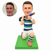 custom bobblehead figure male field hockey player kneeling with a stick across his shoulder