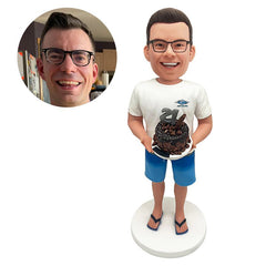personalised bobblehead figure man holding a birthday cake with both hands