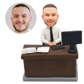 customized bobblehead figure male boss sitting on a desk with a computer