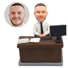 customized bobblehead figure male boss sitting on a desk with a computer