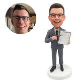 personalized bobblehead figurine businessman salesman pointing a notepad with a pen