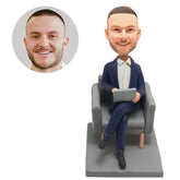 personalized bobblehead salesman businessman boss sits on sofa with a laptop