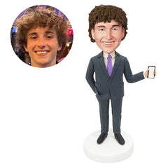 custom bobble head figure man holding a phone