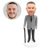customised bobble head figure male boss holding a working stick crutch