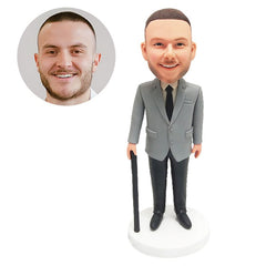 customised bobble head figure male boss holding a working stick crutch